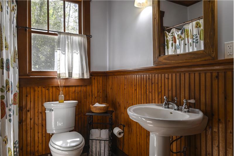 Charming bath with bead board wainscoting.