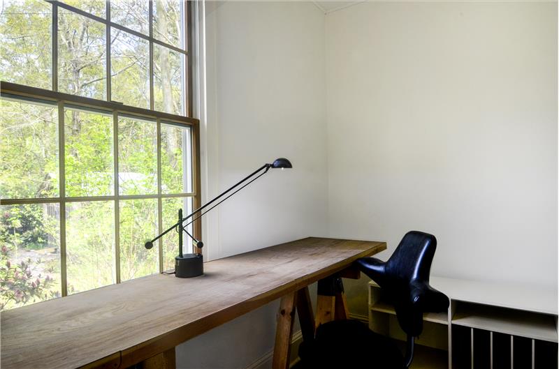 Walk-in closet with window & pretty views currently serving as art studio.