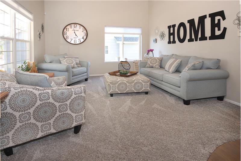Vaulted Living Room with neutral carpet