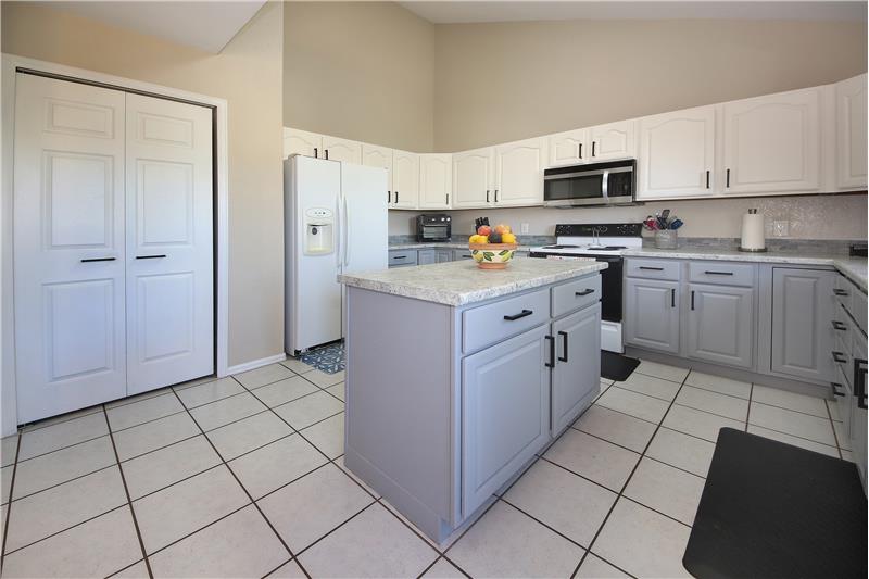 The Kitchen also includes a pantry, electric range oven, built-in microwave oven, side by side refrigerator, and dishwasher