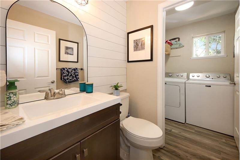Off the lower-level Family Room is an updated Powder Bathroom and Laundry Room with washer & dryer