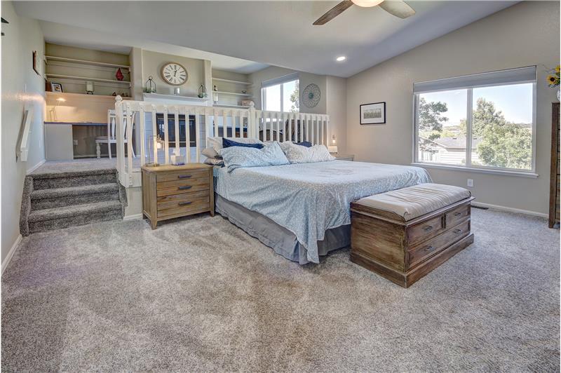 The Master Bedroom features a step-up retreat with gas fireplace & Peak views