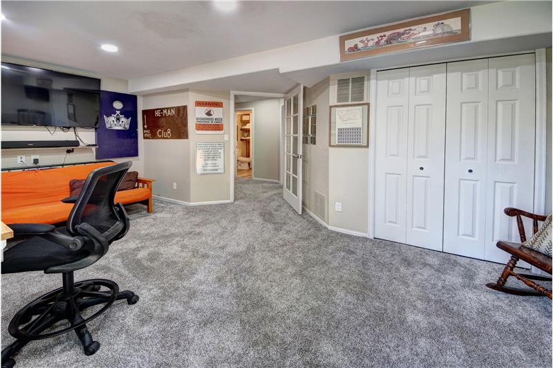 Walkout Basement Recreation Room with recessed lighting and neutral carpet