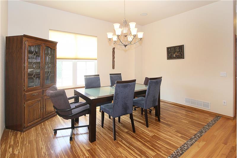 Formal dining room with bamboo flooring and in-ceiling speakers