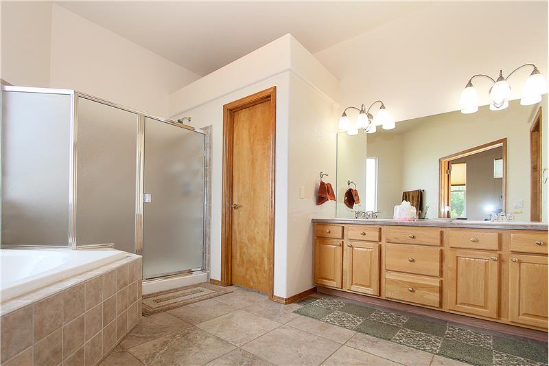Master bathroom with tile flooring and double sink vanity