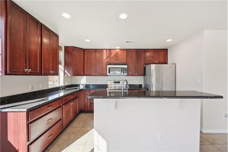 Kitchen has a breakfast bar on the island facing the dining room