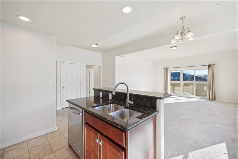 Kitchen island features the double stainless steel sink and extra-quiet dishwasher