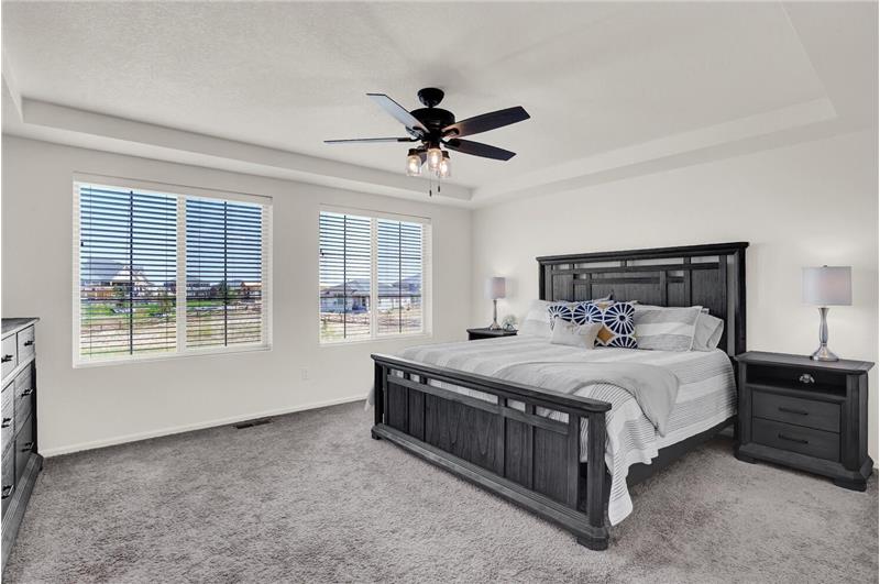 Spacious Master Bedroom with large view windows, a data port, neutral carpet, and attached Master Bathroom
