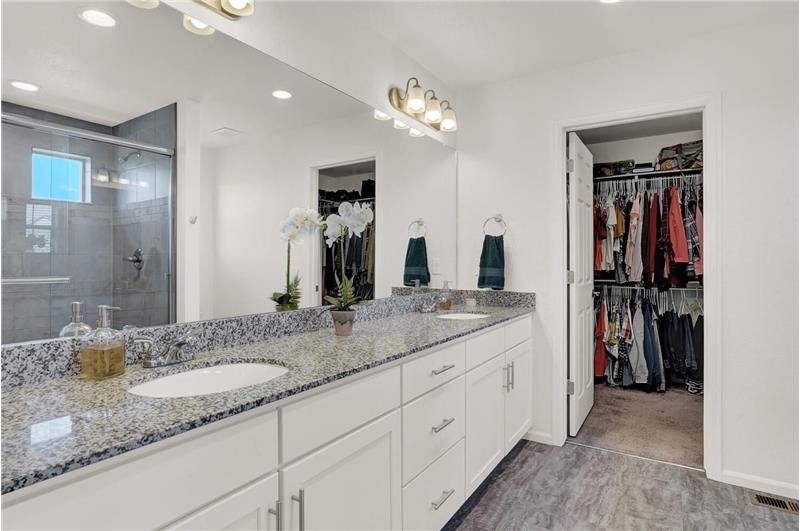Master walk-in closet and dual sink vanity with granite countertops and 2inch extra granite trim