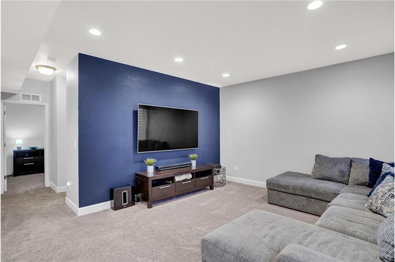 Basement Family Room with a designer paint accent wall in the TV area
