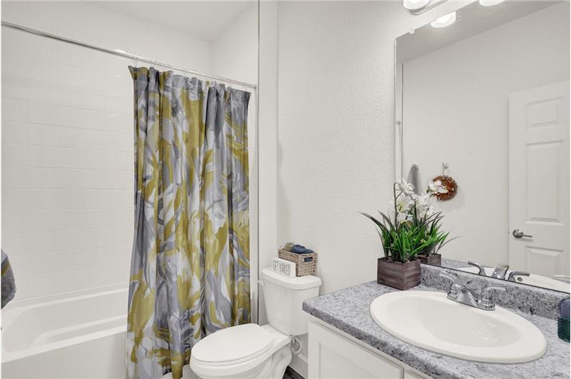 Basement full Bathroom with vanity and tiled soaking tub/shower