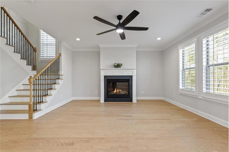 Living room with Linear fireplace with marble accent wall