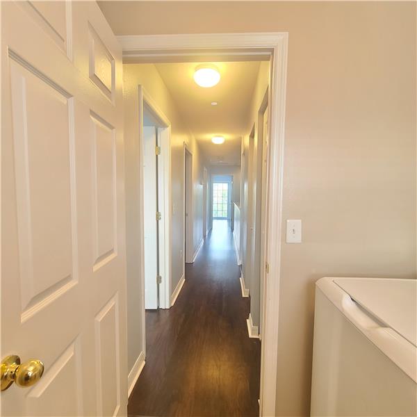 Hallway from the Laundry Room. To the left down the Hall are Bedrooms 2 & 3, Guest Bathroom, at end Master Bedroom