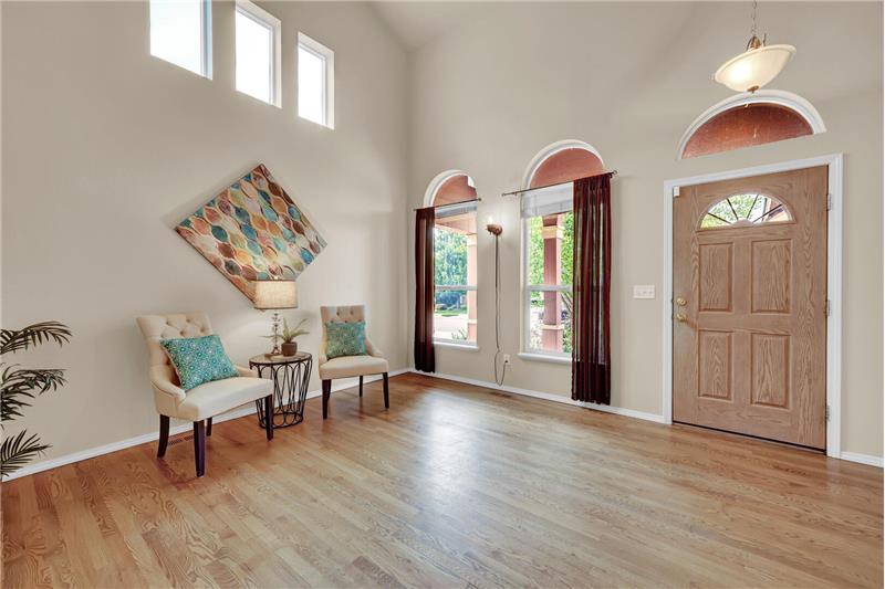 Entry into the Formal Living Room with high vaulted ceilings and abundant natural light