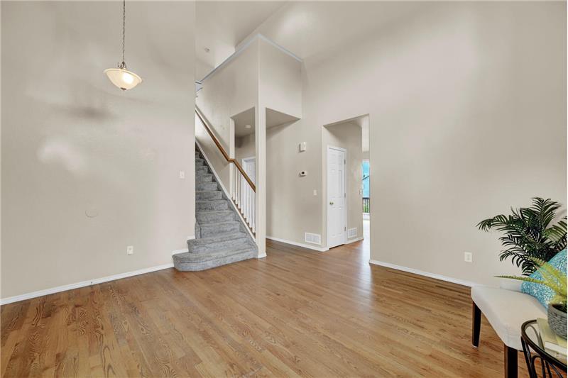 Living Room with stairs to the upper level and entry into the Kitchen