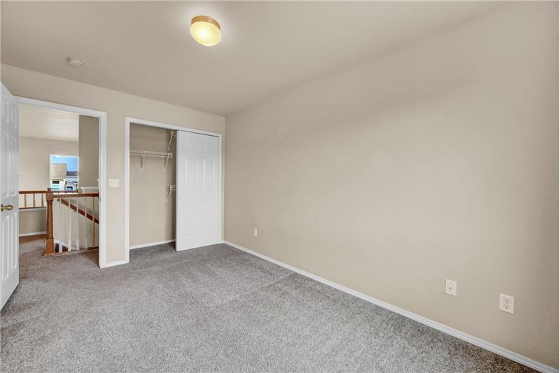 Upper-level Bedroom #2 has a closet and neutral carpet