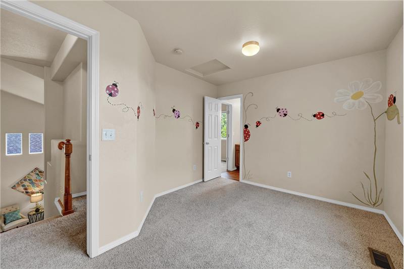 Upper-level BR #3 has a whimsical ladybug theme on the wall and shares a Jack N Jill Bathroom with BR #2