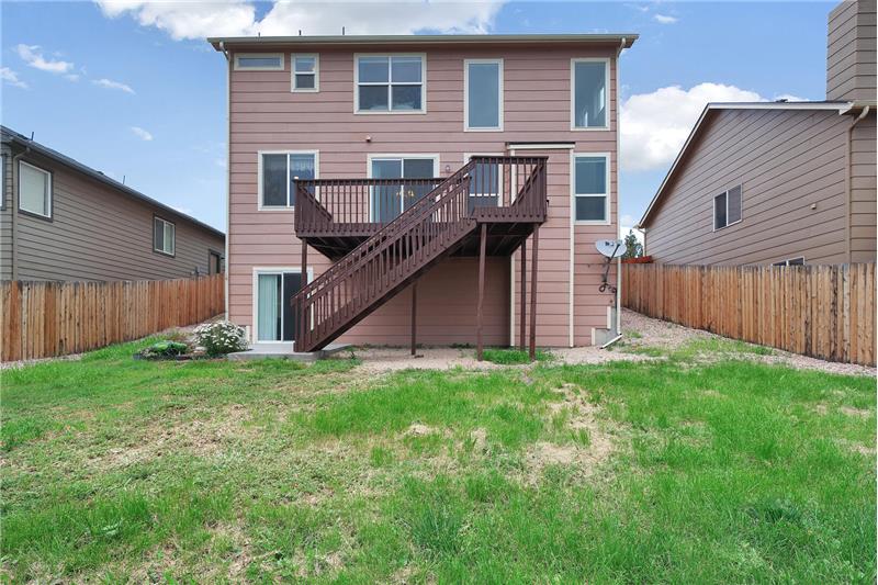 Fenced backyard with deck for outdoor fun