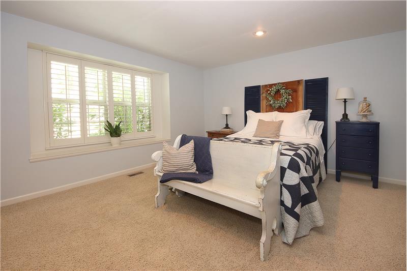 Accommodating master bedroom with plantation shutters