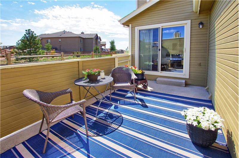 Back patio with gate to green space/common area