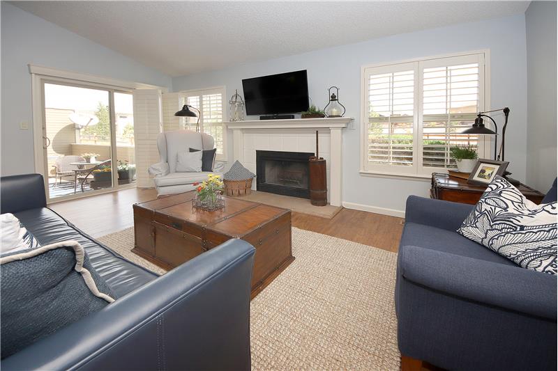 Living room with plentiful windows and a wood burning fireplace