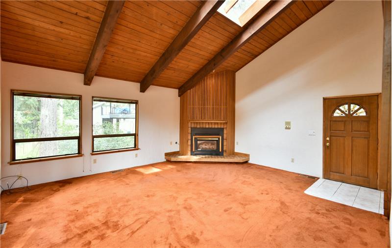 Vaulted wood planked ceilings with exposed beams.  The floor to ceiling fireplace is fueled by natural gas.