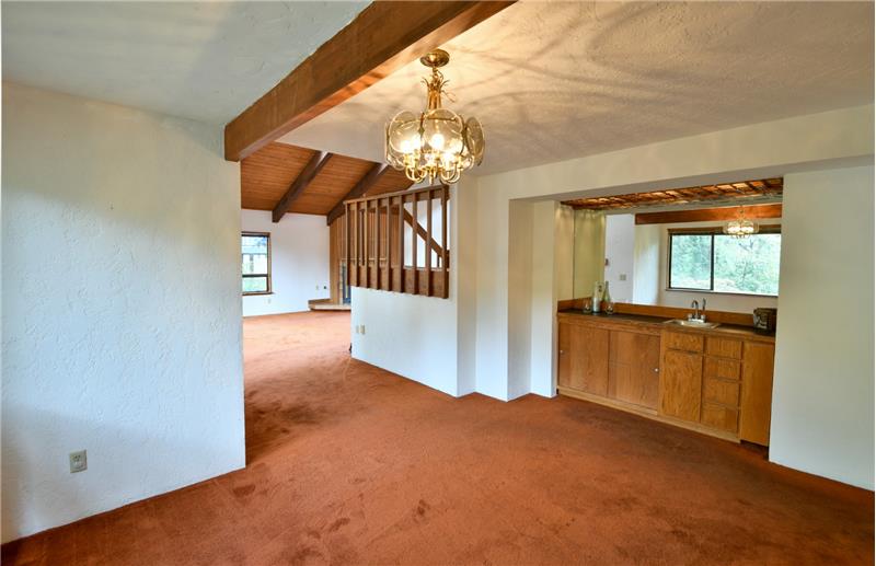 Circling behind the staircase is your formal dining area and wet bar!