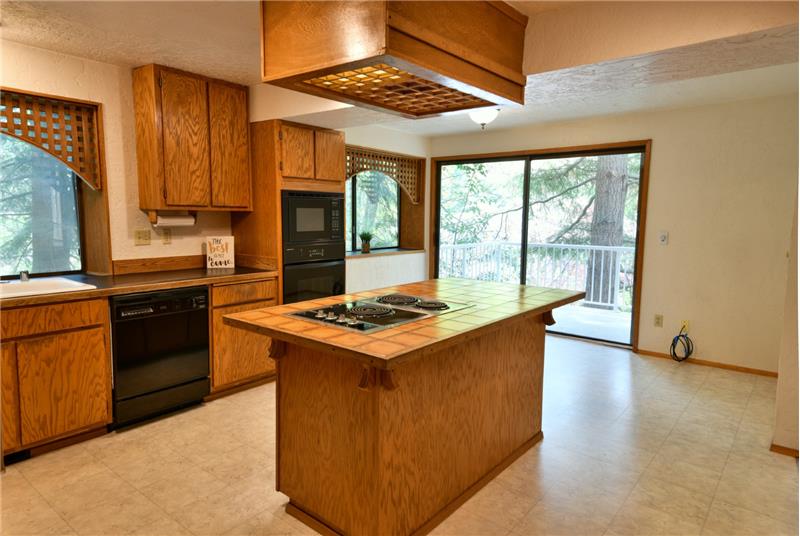 Plenty of room here for an eat in-kitchen area.  The sliding glass door is oversized inviting you out to just one of the decks.