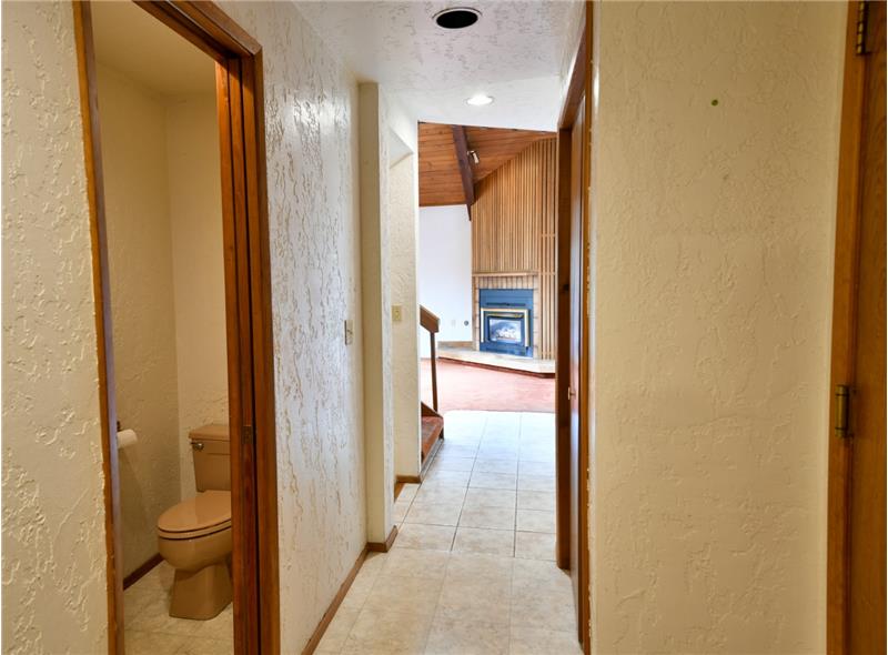 Down the hall is a half bath.  So practical and inconspicuous.  To the right is the garage. You don't want to miss this!