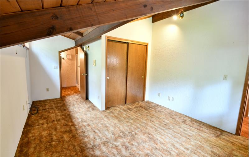 This is the smaller of the 2 bedrooms on the upper level! Yes, that is a private bathroom dedicated to this bedroom.
