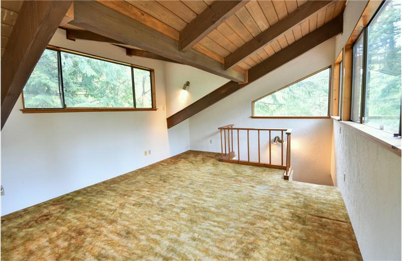 Here is your own private loft area! The beautiful wood railing also carries throughout this unique home.