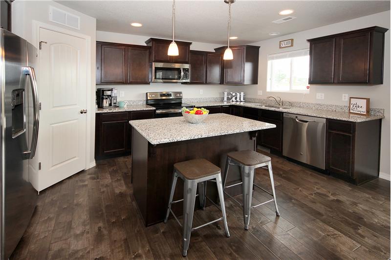Kitchen with recessed lighting and large island with pendant lighting.  Walk-in pantry!