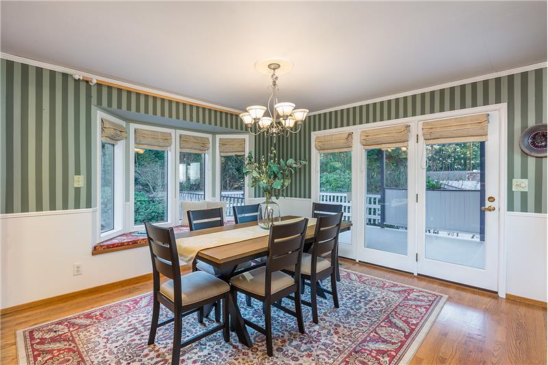 Large, Light and Bright Dining Room with Bay Window, Hardwood Floors, Door Leading to the View Deck, Crown Molding and Built In.