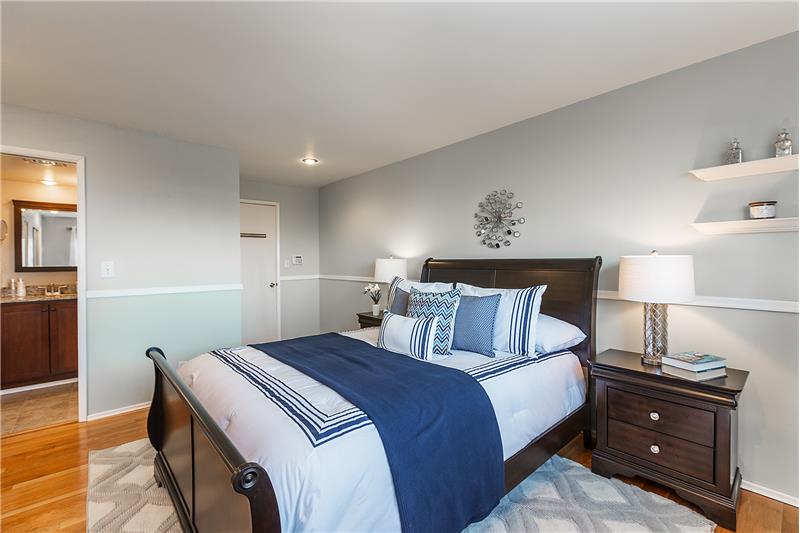 Wake up to the Amazing Views from the Freshly Painted Master Bedroom with Hardwood Floors, Chair Rail and Remodeled 3/4 Bathroom