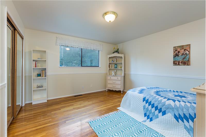 Large, Fourth Bedroom with Chair Rail and Hardwood Floors.