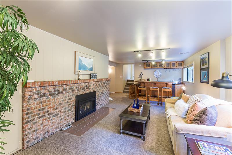 Another View of the Downstairs Family Room with Cozy Brick, Surround Gas Insert with Blower.