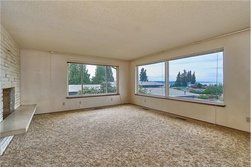 Enjoy the Amazing Views and Sunsets from the Large Living Room that includes a Brick, Gas Fireplace.