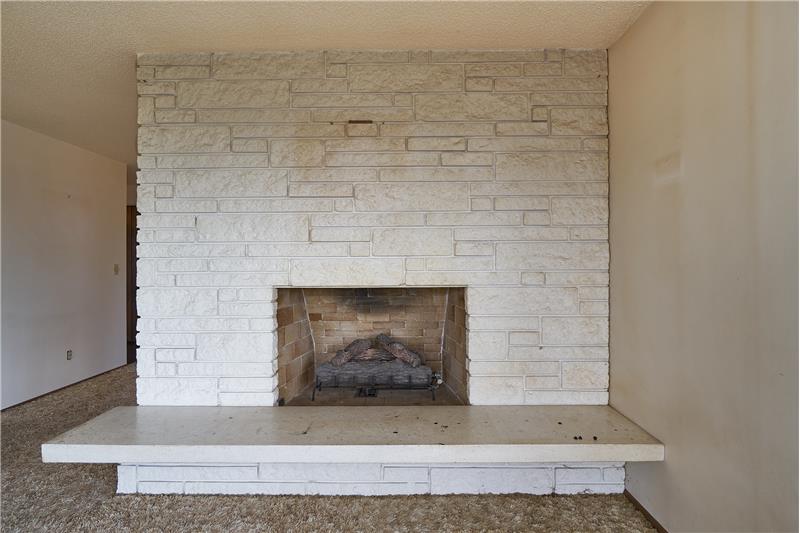 The Huge, Brick Gas Fireplace in the Living Room.