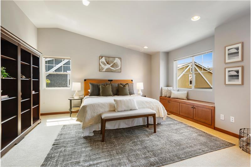 Expansive primary suite features vaulted ceilings.