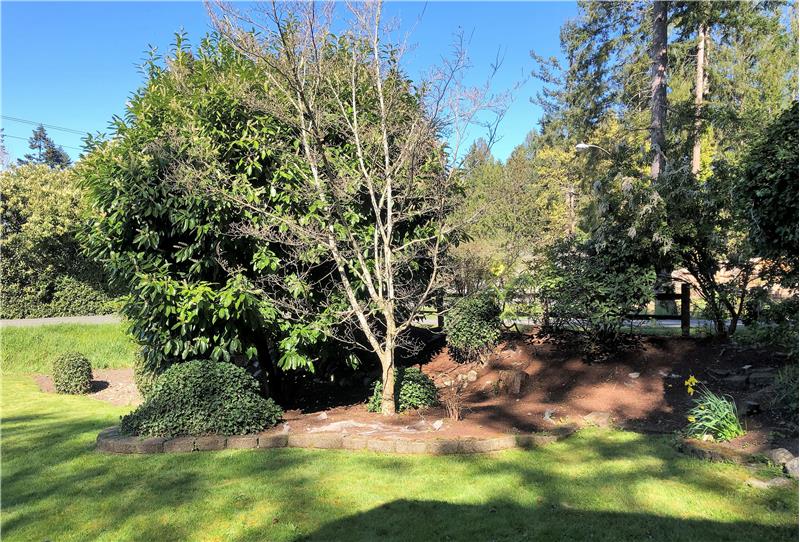 This beautiful landscaped corner lot is about a third of an acre. It feels so much larger!