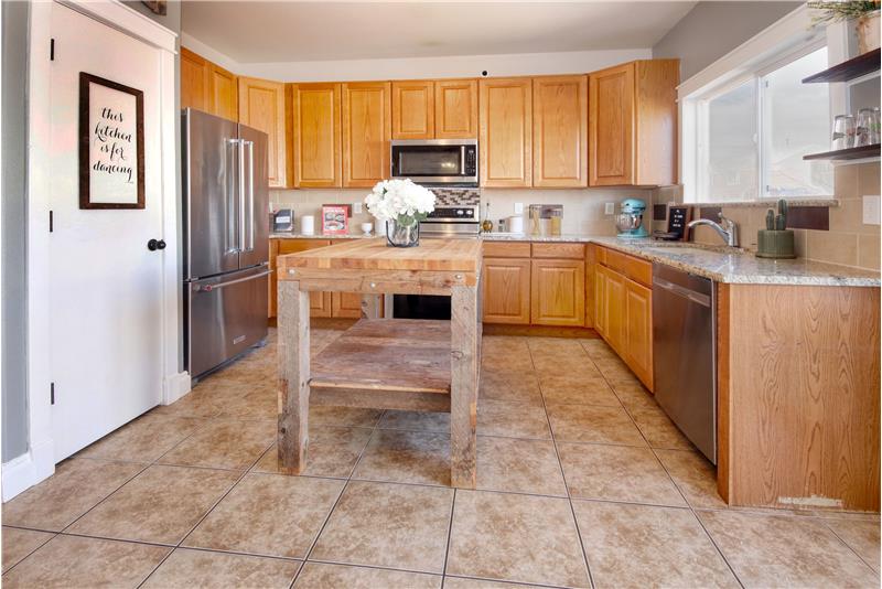 Newer SS appliances include a dishwasher, built-in microwave, French door refrigerator, & smoothtop range double oven