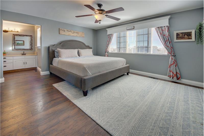 The upper-level Master Bedroom has a lighted ceiling fan, large walk-in closet, & attached Shower Bathroom