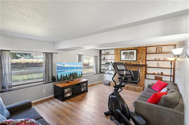Family room, 6 steps down from kitchen, has wood burning fireplace