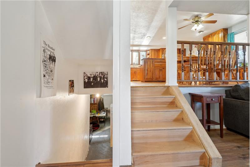 Stairs to basement (left) and to kitchen (right)