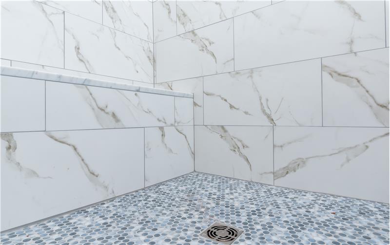 Marble bench and penny tile shower tile floor