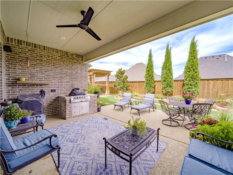 Relax in this private, large patio with outdoor kitchen
