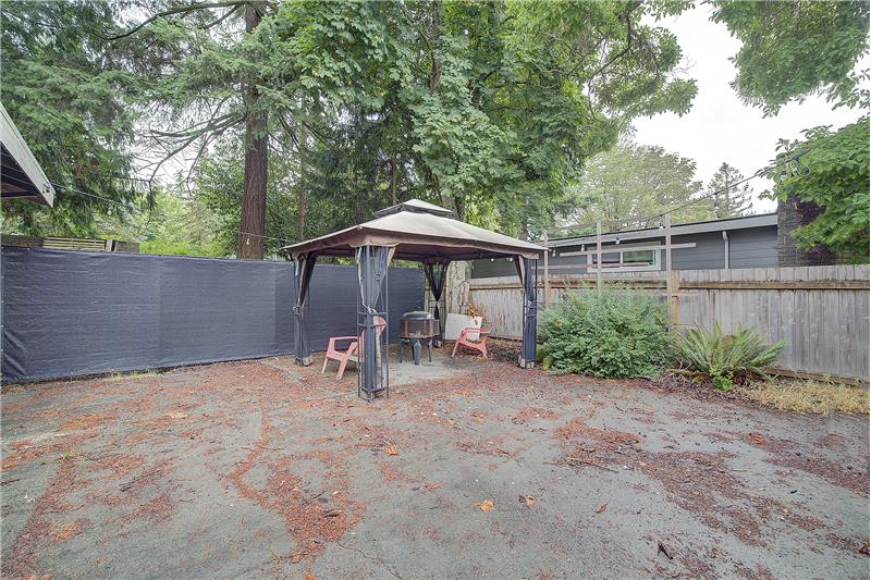 Fenced back yard, owner to retain, the yard area behind the Fabric.