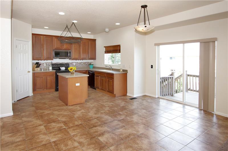 Dining area with tile flooring provides a walk-out to the back deck