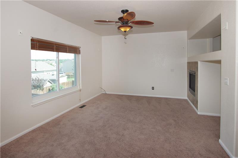 Family room with ceiling fan and gas fireplace