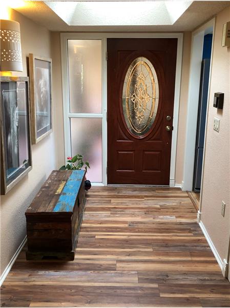 Laminate wood flooring & skylight in entry